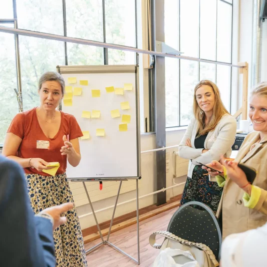 Participants engaging in discussions during a Swiss Triple Impact workshop, exchanging ideas and collaborating on sustainability solutions
